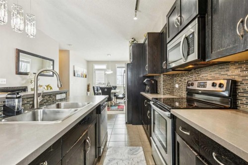 1202-125 Panatella Way Nw, Calgary, AB - Indoor Photo Showing Kitchen With Double Sink With Upgraded Kitchen