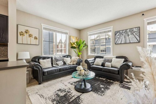 1202-125 Panatella Way Nw, Calgary, AB - Indoor Photo Showing Living Room
