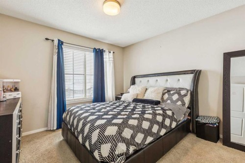 1202-125 Panatella Way Nw, Calgary, AB - Indoor Photo Showing Bedroom