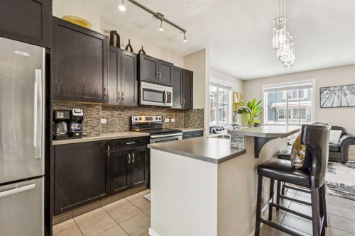 1202-125 Panatella Way Nw, Calgary, AB - Indoor Photo Showing Kitchen With Upgraded Kitchen