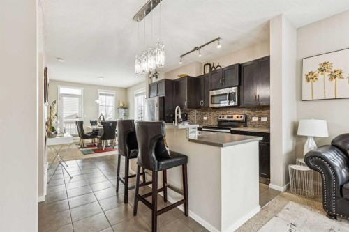 1202-125 Panatella Way Nw, Calgary, AB - Indoor Photo Showing Kitchen With Upgraded Kitchen