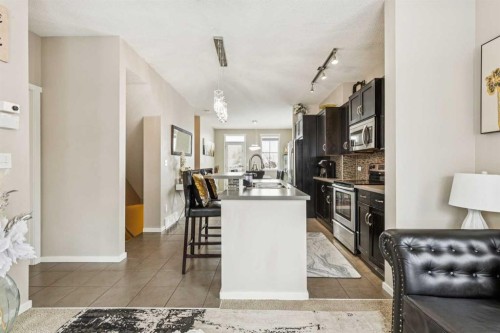 1202-125 Panatella Way Nw, Calgary, AB - Indoor Photo Showing Kitchen With Upgraded Kitchen