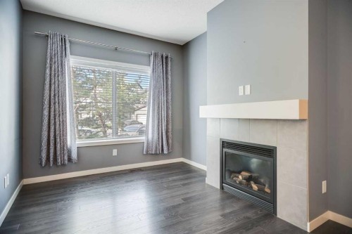 384 Copperpond Landing Se, Calgary, AB - Indoor Photo Showing Living Room With Fireplace