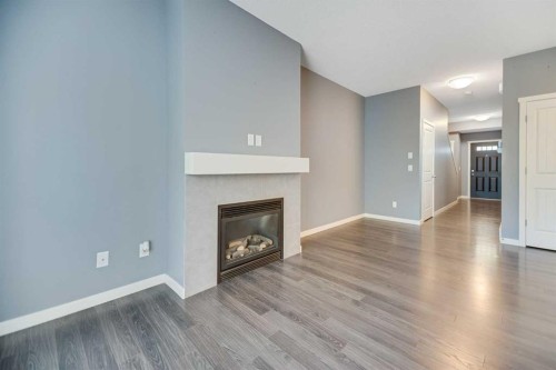 384 Copperpond Landing Se, Calgary, AB - Indoor Photo Showing Living Room With Fireplace