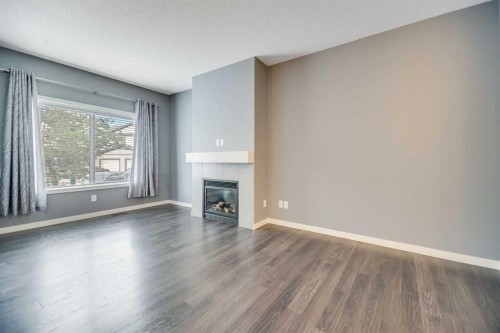 384 Copperpond Landing Se, Calgary, AB - Indoor Photo Showing Living Room With Fireplace