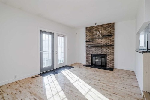 128 Bermuda Drive Nw, Calgary, AB - Indoor Photo Showing Living Room With Fireplace