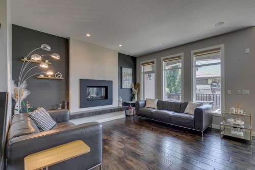119 Marquis Crescent Se, Calgary, AB - Indoor Photo Showing Living Room With Fireplace