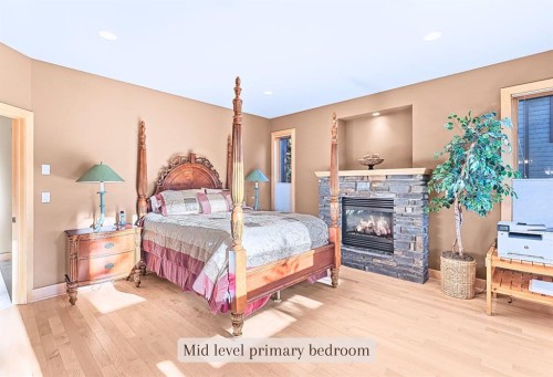 1-125 Stonecreek Road, Canmore, AB - Indoor Photo Showing Bedroom With Fireplace