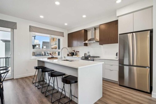 132 Quesnay Wood Link Sw, Calgary, AB - Indoor Photo Showing Kitchen With Upgraded Kitchen