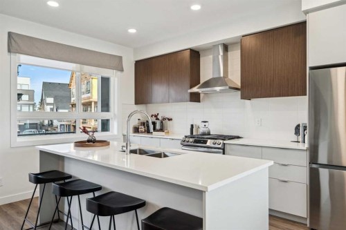 132 Quesnay Wood Link Sw, Calgary, AB - Indoor Photo Showing Kitchen With Double Sink With Upgraded Kitchen