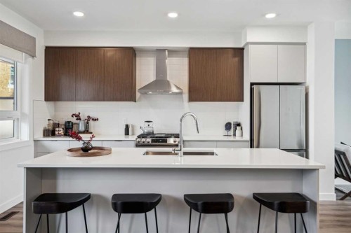 132 Quesnay Wood Link Sw, Calgary, AB - Indoor Photo Showing Kitchen With Upgraded Kitchen