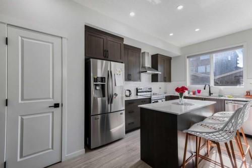 15 Edith Passage Nw, Calgary, AB - Indoor Photo Showing Kitchen With Double Sink