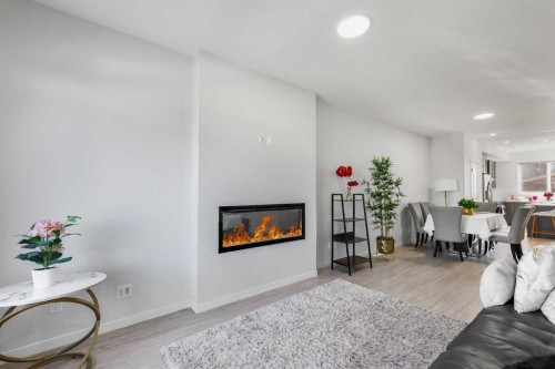 15 Edith Passage Nw, Calgary, AB - Indoor Photo Showing Living Room With Fireplace
