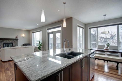 1796 Panatella Boulevard Nw, Calgary, AB - Indoor Photo Showing Kitchen With Fireplace With Double Sink