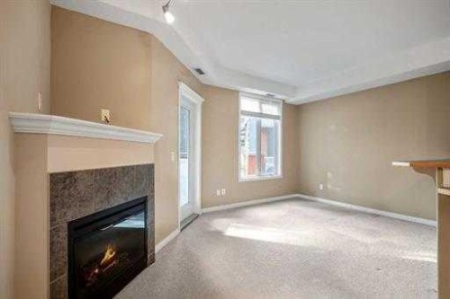 108-15 Everstone Drive Sw, Calgary, AB - Indoor Photo Showing Other Room With Fireplace