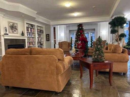 108-15 Everstone Drive Sw, Calgary, AB - Indoor Photo Showing Living Room With Fireplace