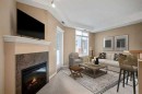 108-15 Everstone Drive Sw, Calgary, AB  - Indoor Photo Showing Living Room With Fireplace 