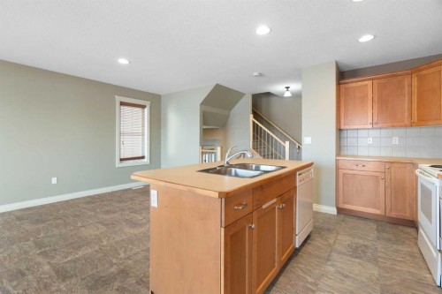 17 Deer Coulee Drive, Didsbury, AB - Indoor Photo Showing Kitchen With Double Sink