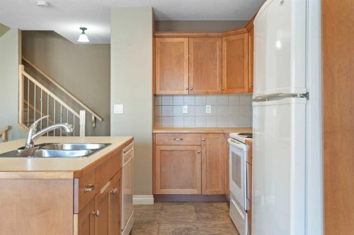 17 Deer Coulee Drive, Didsbury, AB - Indoor Photo Showing Kitchen With Double Sink