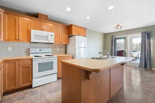 17 Deer Coulee Drive, Didsbury, AB - Indoor Photo Showing Kitchen With Double Sink