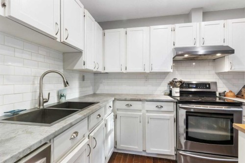 37 Benchlands Drive, Cochrane, AB - Indoor Photo Showing Kitchen With Double Sink
