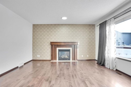 142 Everoak Green Sw, Calgary, AB - Indoor Photo Showing Living Room With Fireplace