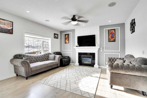 85 Saddlebrook Circle Ne, Calgary, AB - Indoor Photo Showing Living Room With Fireplace