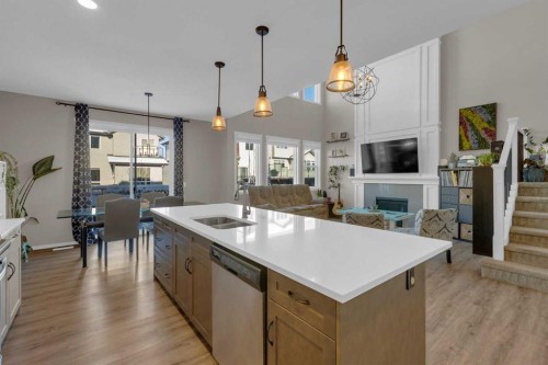 173 Kingsbury Close Se, Airdrie, AB - Indoor Photo Showing Kitchen With Fireplace With Double Sink