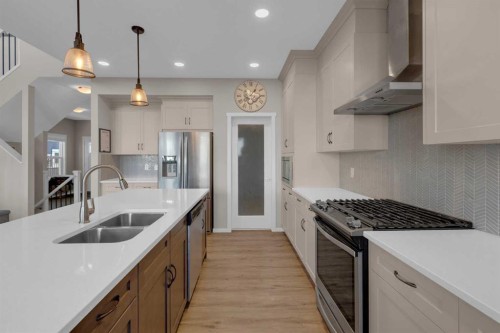 173 Kingsbury Close Se, Airdrie, AB - Indoor Photo Showing Kitchen With Stainless Steel Kitchen With Double Sink With Upgraded Kitchen