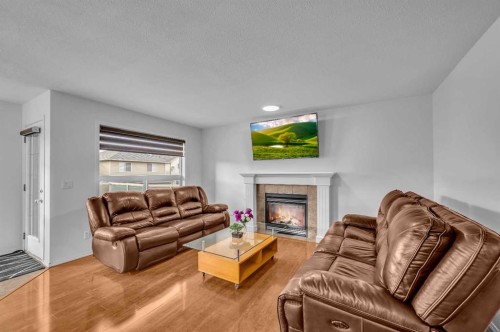 57 Saddlecrest Park Ne, Calgary, AB - Indoor Photo Showing Living Room With Fireplace
