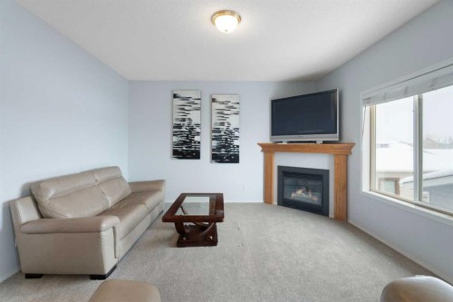 46 Bridleridge Way Sw, Calgary, AB - Indoor Photo Showing Living Room With Fireplace