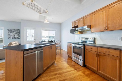 46 Bridleridge Way Sw, Calgary, AB - Indoor Photo Showing Kitchen With Double Sink