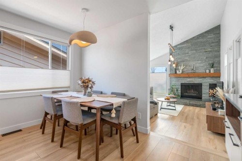 7132 36 Avenue Nw, Calgary, AB - Indoor Photo Showing Dining Room With Fireplace