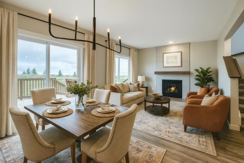 230 Wildrose Drive, Strathmore, AB - Indoor Photo Showing Dining Room With Fireplace