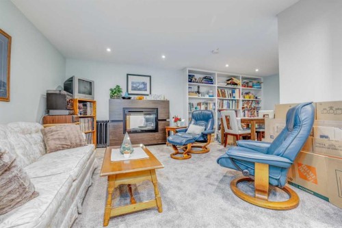 25 Highwood Place Nw, Calgary, AB - Indoor Photo Showing Living Room With Fireplace