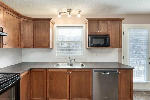 1102 Prairie Sound Circle Nw, High River, AB - Indoor Photo Showing Kitchen With Double Sink