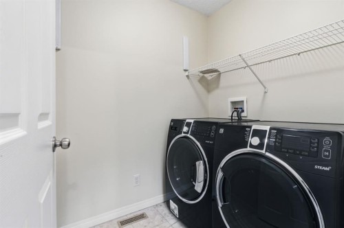 64 Cougarstone Square Sw, Calgary, AB - Indoor Photo Showing Laundry Room