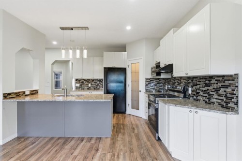 64 Cougarstone Square Sw, Calgary, AB - Indoor Photo Showing Kitchen With Double Sink With Upgraded Kitchen