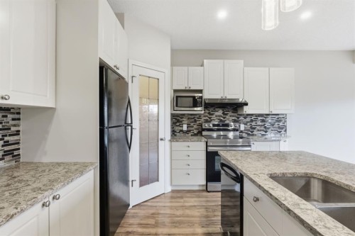 64 Cougarstone Square Sw, Calgary, AB - Indoor Photo Showing Kitchen With Upgraded Kitchen