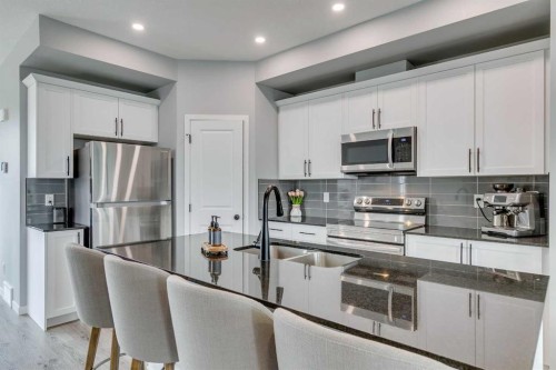 63 Wolf Gate, Okotoks, AB - Indoor Photo Showing Kitchen With Double Sink With Upgraded Kitchen