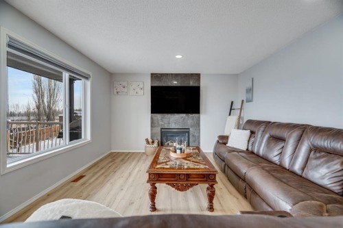 104 Cove Crescent, Chestermere, AB - Indoor Photo Showing Living Room With Fireplace