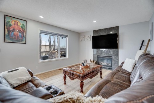 104 Cove Crescent, Chestermere, AB - Indoor Photo Showing Living Room With Fireplace