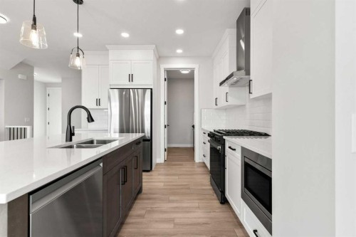 315 Kinniburgh Loop, Chestermere, AB - Indoor Photo Showing Kitchen With Stainless Steel Kitchen With Double Sink With Upgraded Kitchen
