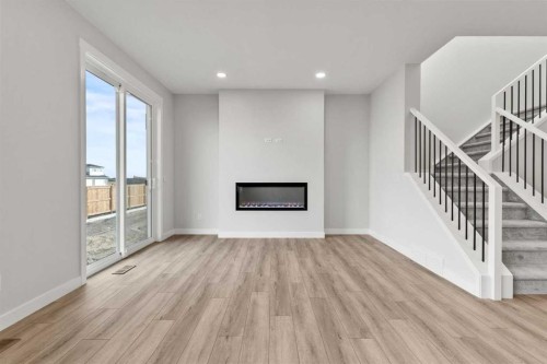 315 Kinniburgh Loop, Chestermere, AB - Indoor Photo Showing Other Room With Fireplace