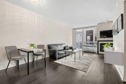 1526-222 Riverfront Avenue Sw, Calgary, AB - Indoor Photo Showing Living Room With Fireplace