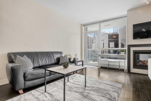 1526-222 Riverfront Avenue Sw, Calgary, AB - Indoor Photo Showing Living Room With Fireplace