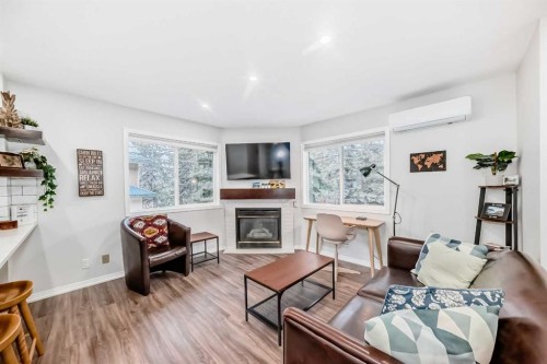 108-1000 Harvie Heights Road, Harvie Heights, AB - Indoor Photo Showing Living Room With Fireplace