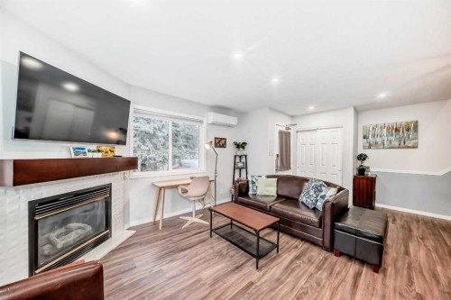 108-1000 Harvie Heights Road, Harvie Heights, AB - Indoor Photo Showing Living Room With Fireplace