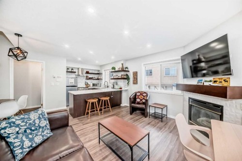 108-1000 Harvie Heights Road, Harvie Heights, AB - Indoor Photo Showing Living Room With Fireplace