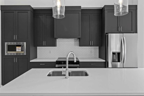 601-15 Coopersfield Link Sw, Airdrie, AB - Indoor Photo Showing Kitchen With Double Sink